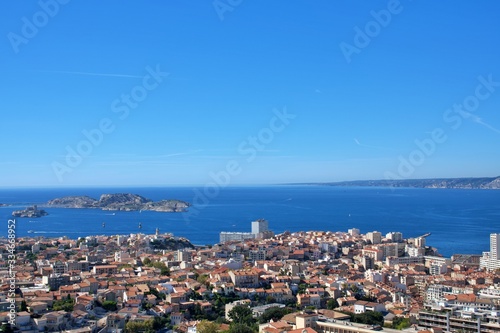 Panoramic view of beautiful Marseille, France under blue sky; aerial photograph of blue sea and city