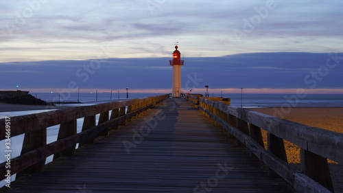 Lighthouse and wooden bridge of Trouville-sur-Mer  Normandy  France at sunset