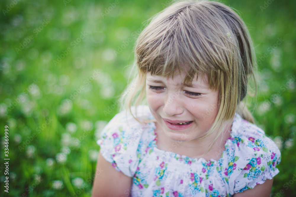 very upset young girl crying outdoors very upset young girl crying outdoors