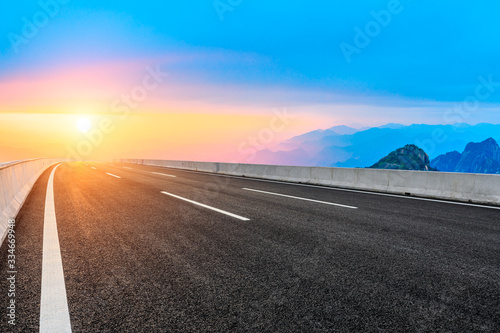 Empty road and mountain with sky sunset clouds landscape.