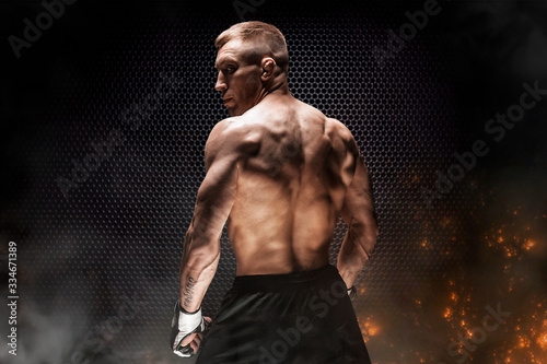 Obraz na płótnie Mixed Martial Arts fighter posing on a metal grid background