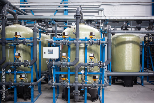 huge plastic containers for storing and producing water, drinking water purification, factory production, tanks filled with liquid, strategic supply of water