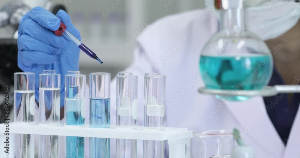 Close up scene video of scientist dropping blue liquid into test tubes, concept for doing experiment in laboratory room.
Close up scene video of scientist dropping blue liquid into test tubes, concept for doing experiment in laboratory room.
