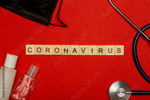 Coronavirus COVID-19 epidemic concept. Coronovirus on a red background with alcohol gel, hand sanitizer and mask