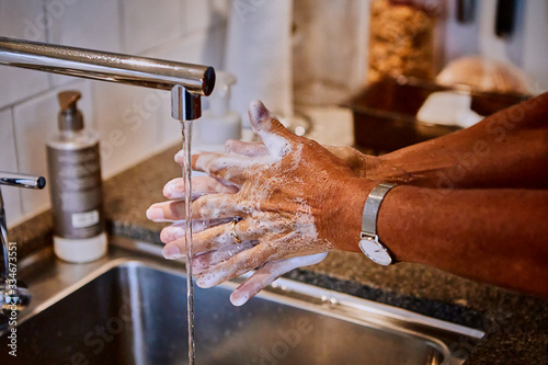 Woman washing her hands.