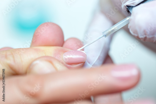 Close-up shot of a woman in manicure. Woman gets a manicure for nails