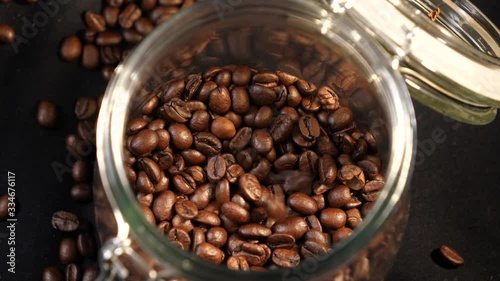  Coffee beans fall in a jar. Coffee beans. Coffee. Drink. The production of coffee. Close-up.