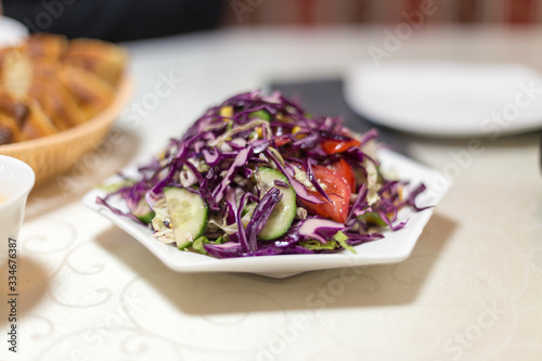 cabbage-based vegetable salad on a table in a restaurant