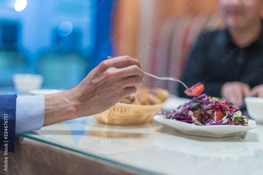 man eating coleslaw in a restaurant man eating coleslaw in a restaurant