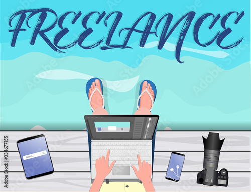 Freelance concept. Freelancer-photographer-illustrator-stocker working with laptop near the sea. With text Freelance