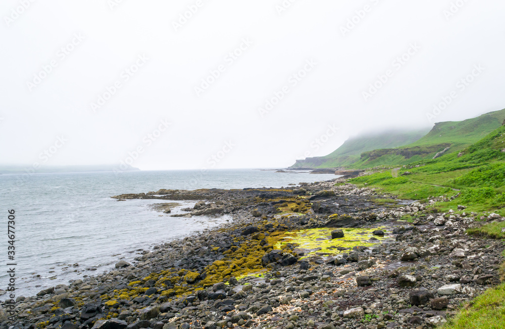 Landscape view of Calgary beach seen from the characteristic rocks in Mull island, one of the main of the inner Hebrides in Scotland. It was a foggy summer day and the atmosphere was quiet and wet