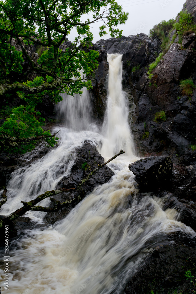 Nice natural and wild spot in Mull island, one of the main isles in the inner Hebrides in Scotland. Here a little waterfall surrounded by green trees and brack rocks