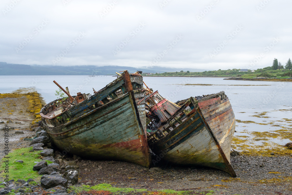 A very interesting spot in Mull island, in the inner Hebrides in Scotland. Two old wooden boats, once nice and colorful, left on the beach became almost a landmark for their adaptation with this place