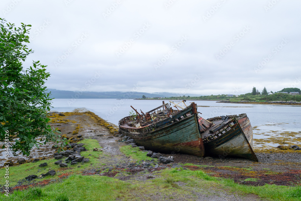 A very interesting spot in Mull island, in the inner Hebrides in Scotland. Two old wooden boats, once nice and colorful, left on the beach became almost a landmark for their adaptation with this place