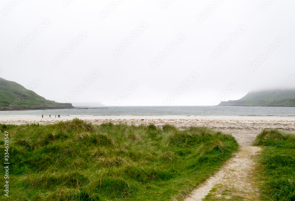 Landscape view of Calgary beach seen from the dirt natural path in Mull island, one of the main of the inner Hebrides in Scotland. It was a foggy summer day and the atmosphere was quiet and wet