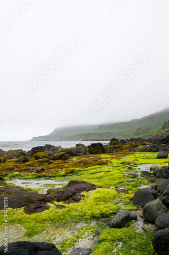 Landscape view of Calgary beach seen from the characteristic rocks in Mull island, one of the main of the inner Hebrides in Scotland. It was a foggy summer day and the atmosphere was quiet and wet