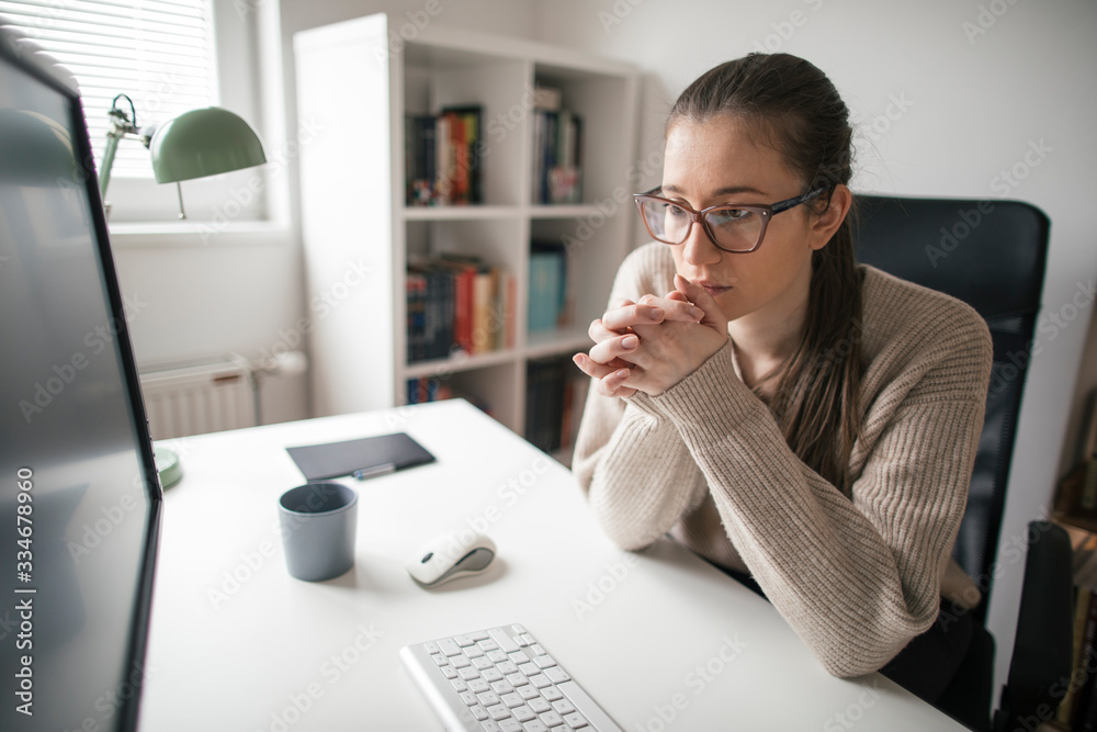 Young businesswoman working long hours from home office Young businesswoman working long hours from home office