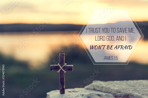 Christian verse bible, James 1:5, saying the Lord will save me and I won’t be afraid. Sunrise background with cross