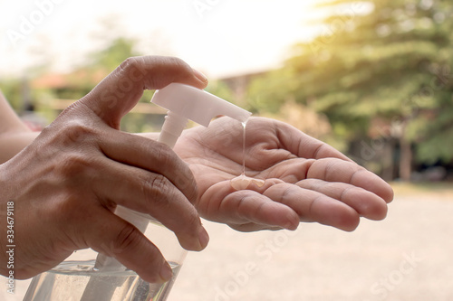 The woman's hand is pressing the hand sanitizer for virus infection and pandemic, arterial virus prevention or covid-19 for health care and disease prevention concepts. © Arthon