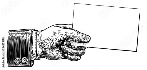 A hand holding business card or flyer frame message sign with copyspace