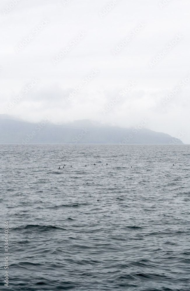 The moody seascape of the North Atlantic ocean in a foggy summer day. The shot has been taken from a little ferry boat that took me from Mull island to the liytle and wild Staffa island in Scotland