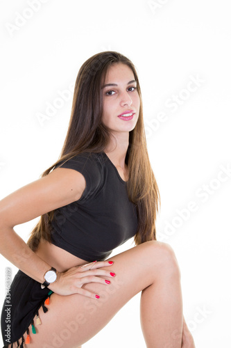 Young beautiful brunette girl model posing against a white wall background