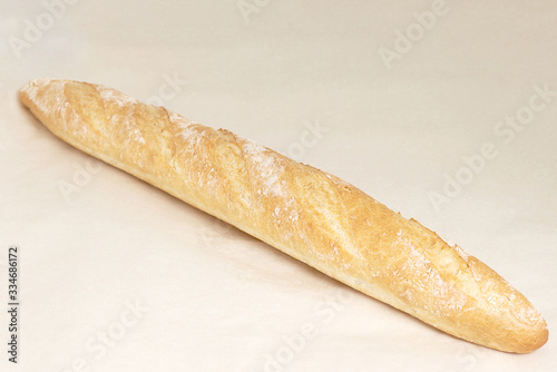 French baguette, an assortment of baked goods. Closeup on a light background