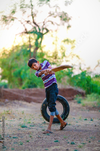 Rural Indian Child Playing Cricket