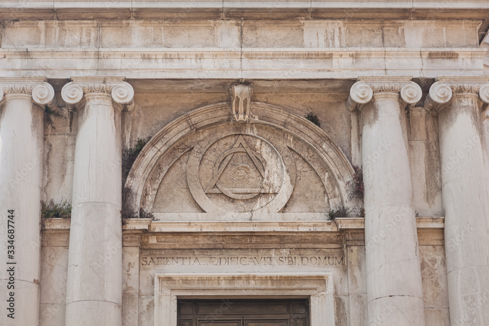eye sign inside triangle on building of Church of St. Magdalena, Venice, Italy
