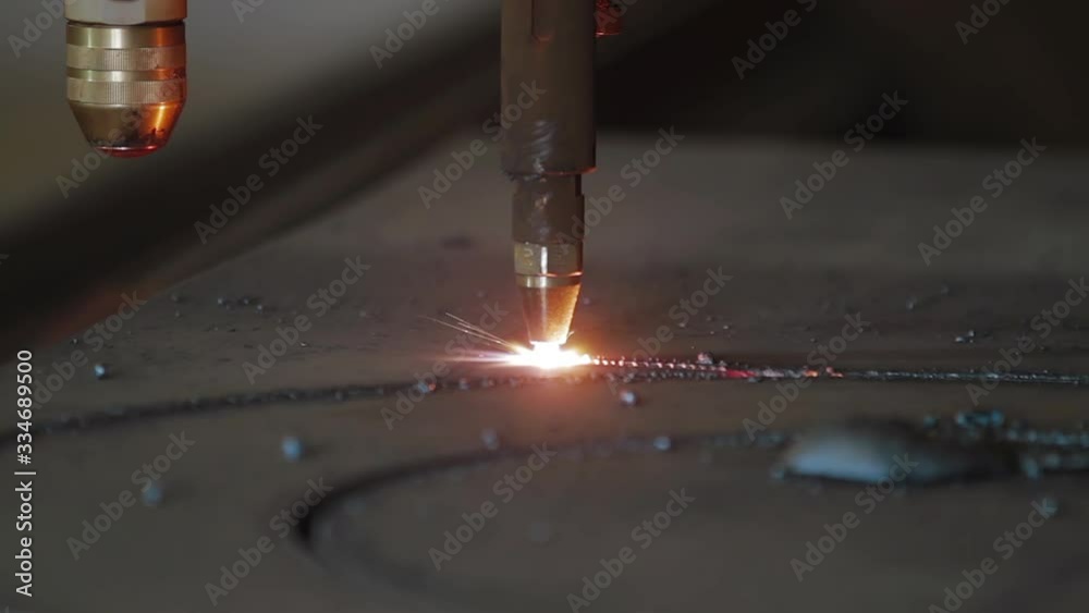 Plasma cutting of metal with a cnc. A plasma cutter cuts a workpiece from a sheet of metal. Laser cutter in production. Industrial metal cutting by plasma laser.