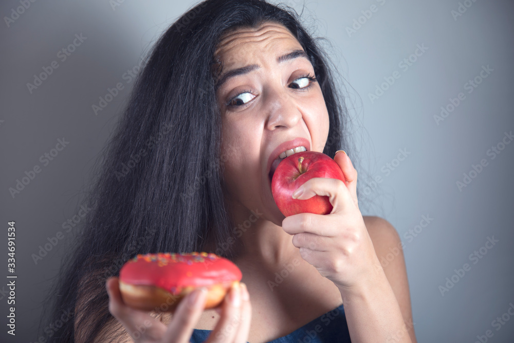 woman hand holding Donut and apple woman hand holding Donut and apple