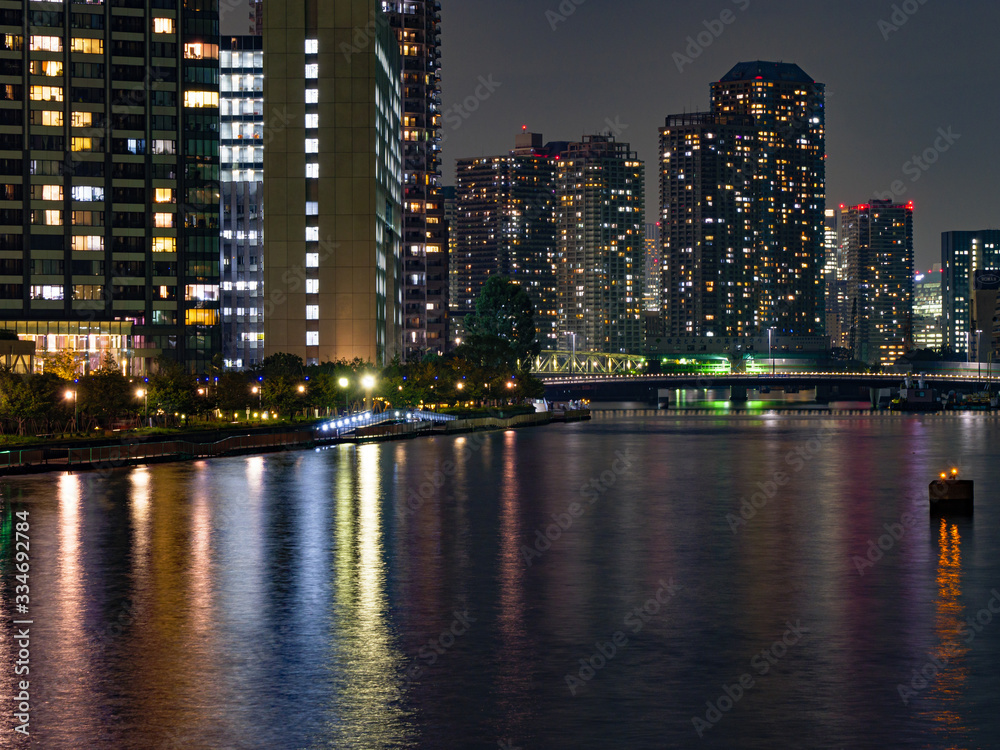 High rise buildings in Tokyo reflected in a river
