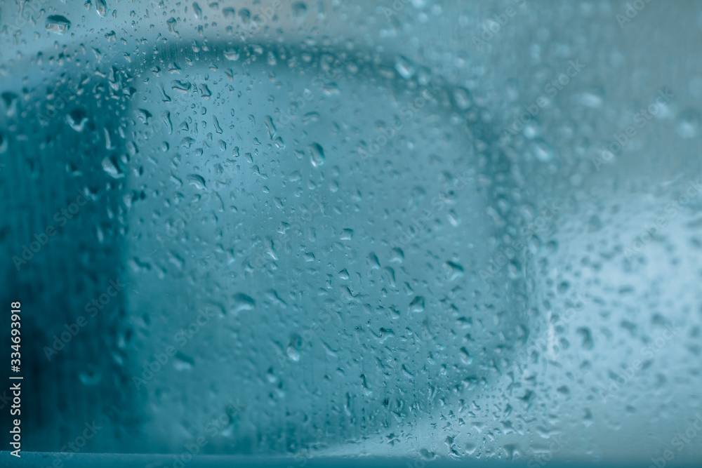 Obraz premium Rainy weather. First rains, inside view. Raindrops on a car side window