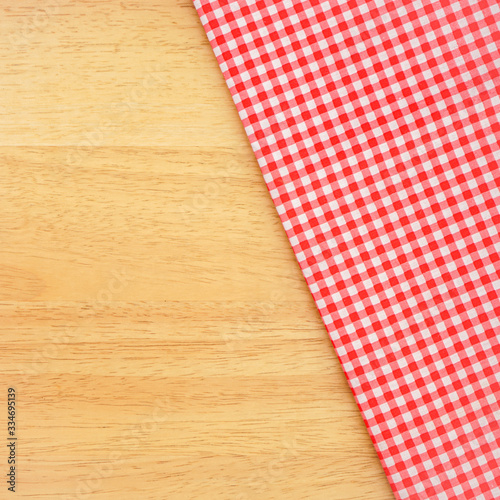 red and white classic tablecloth on wooden background