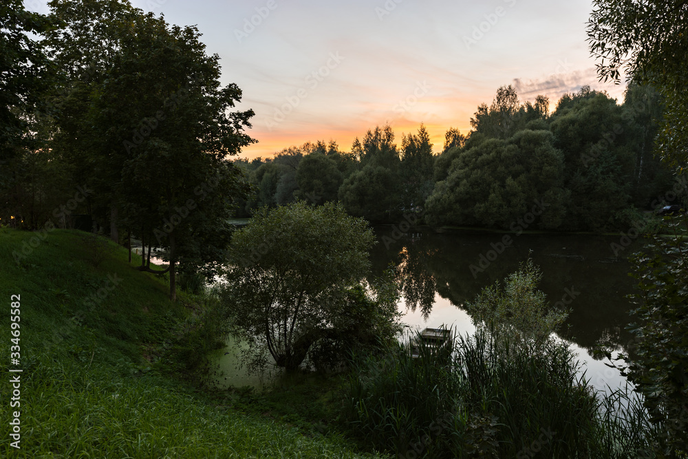 Landscape of russian nature and Desna river among greenery and trees in summer twilight in Zarechie park in Troitsk