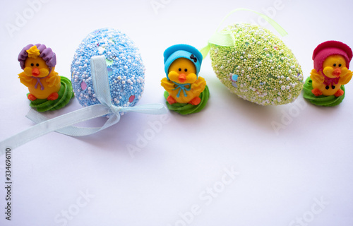 Easter eggs and two chicks on a white background
