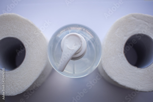 Hand soap and toilet paper on a white background