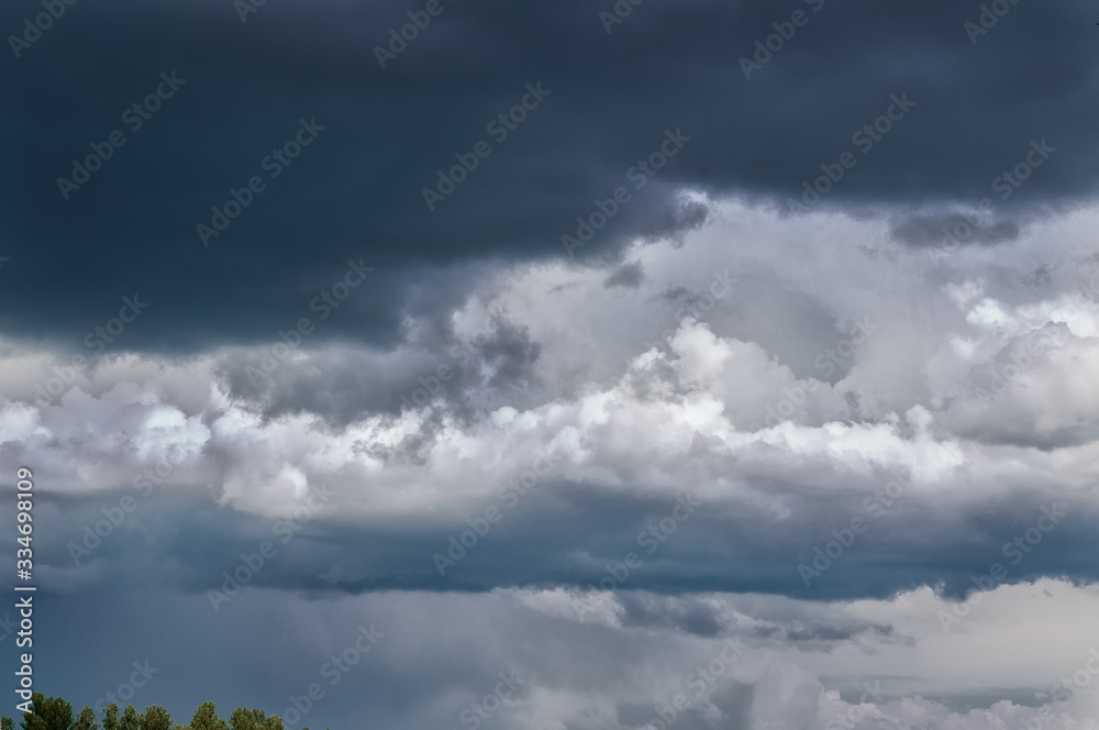 Gray white clouds. Clouds of thunderclouds on a blue sky. Summer day. Beautiful nature background