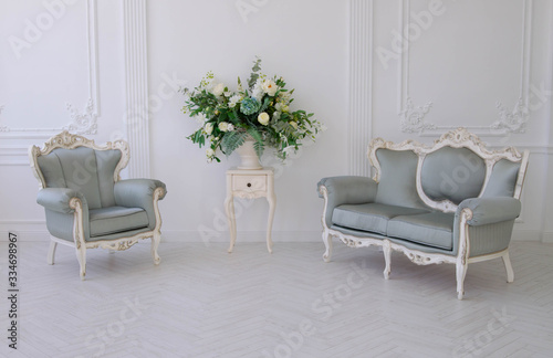 Gray sofa and armchair in a white room