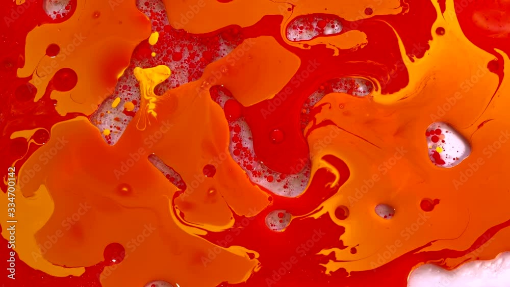 Red and yellow watercolor ink in water with oil. Slow motion video. Planets, the universe and space. Cool trending screensaver. Abstract background. Red and yellow watercolor ink in water with oil. Slow motion video. Planets, the universe and space. Cool trending screensaver. Abstract background.