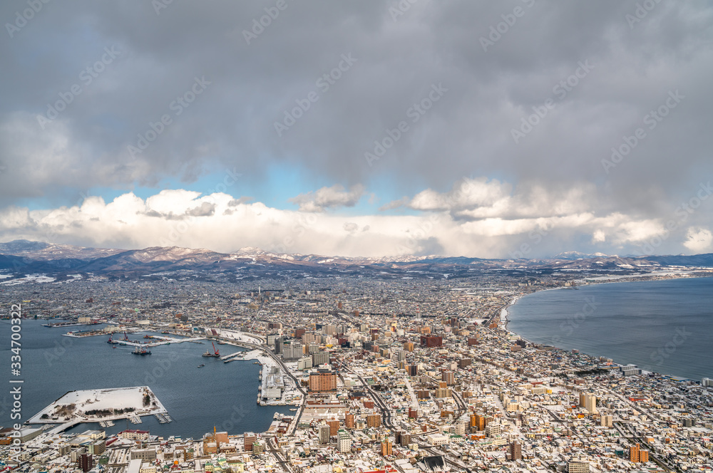 View of Hakodate in the island of Hokkaido, Japan, on a winter day with snow and clouds.