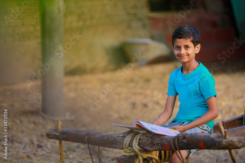 Cute indian child studying at home © PRASANNAPIX