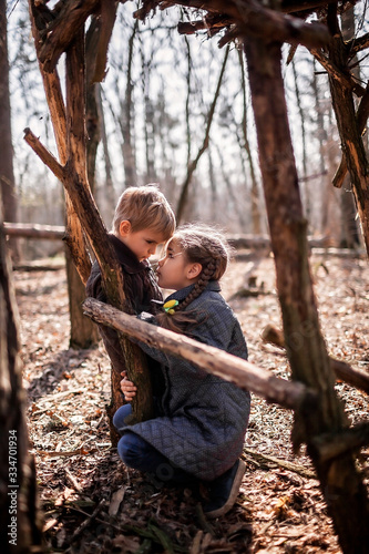 Young adventurers building a wooden habitat in the wild forest during social distant walking