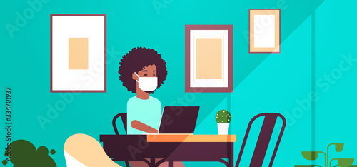 african american woman in protective mask using laptop coronavirus pandemic quarantine concept work from home online education freelance modern living room interior portrait horizontal vector
