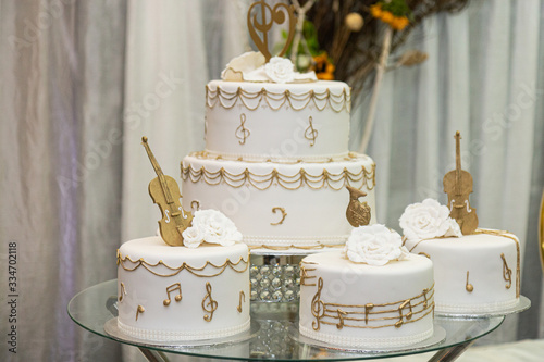 White wedding cake with golden decorations