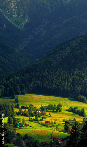 Panoramic view of a Tatra Mountains valley with meadows and farms seen from Toporowa Cyrhla village near Zakopane in Poland