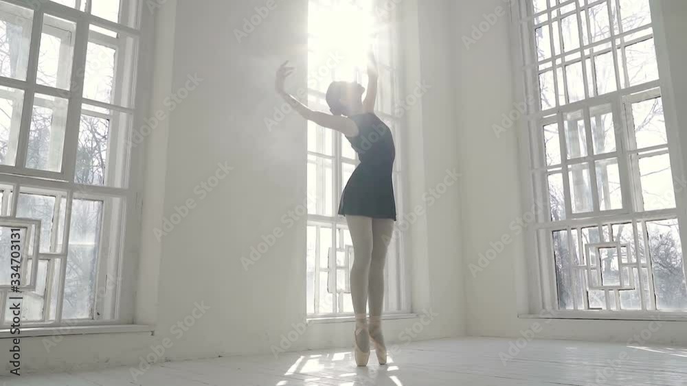 Ballerina standing near the window and practicing in dance. Slowmotion. Ballerina standing near the window and practicing in dance. Slowmotion.