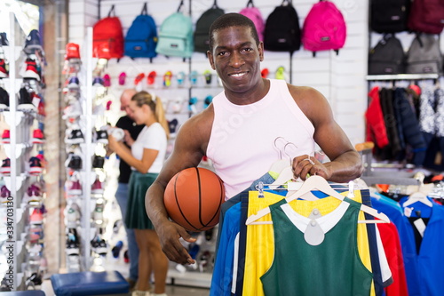 Male customer holding sport clothes