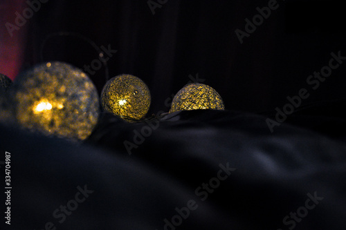 Light laying on the bed sheets look like silk bright lights with dark background.