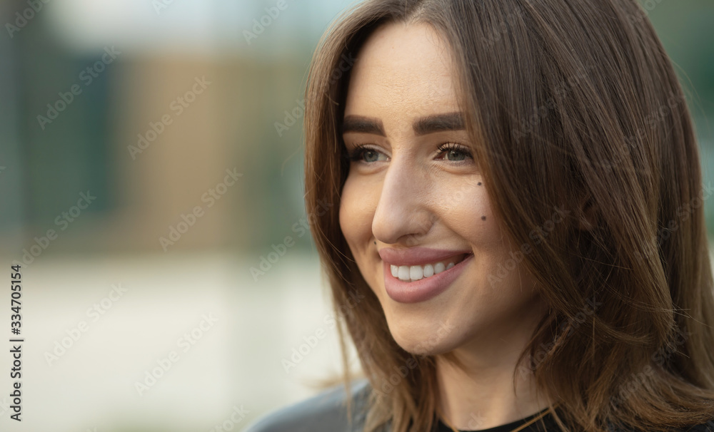 Portrait of beautiful young happy smiling woman, outdoors, with copy space. Portrait of beautiful young happy smiling woman, outdoors, with copy space.